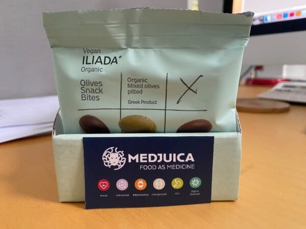 Display pack with organic olives with a Medjuica sticker at the front showing health icons